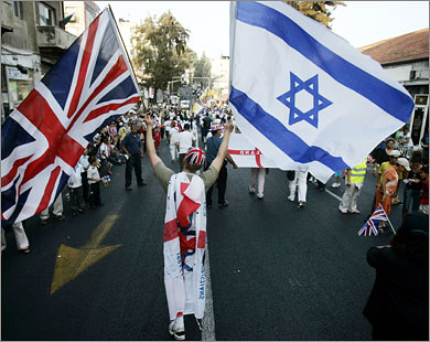 1_724893_1_34 AFP A Christian Evangelical from the United Kingdom waves Israeli and British flags during a parade in celebration of the Jewish holiday of Sukkoth, in downtown