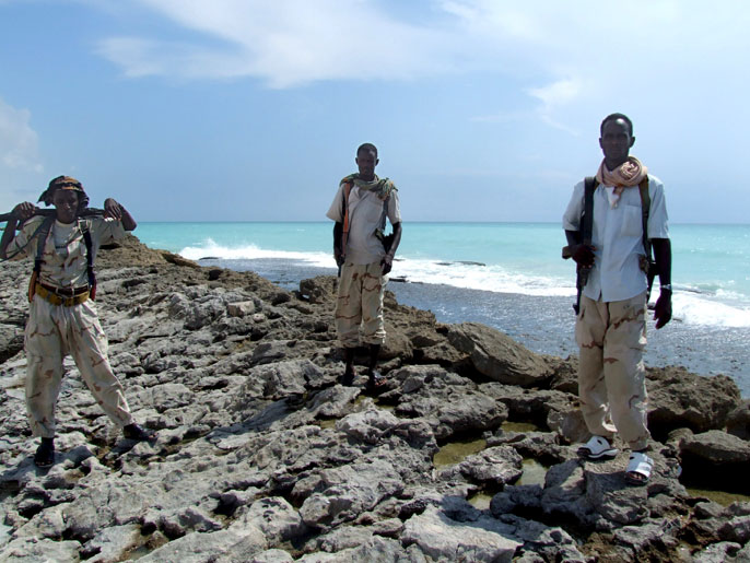 9bef1bfb-817f-44ec-a34d-9f98ec04e3c3 epa01527471 In the 16 October 2008 photo made available on 22 October 2008 armed Somali pirates guard the beach in Hobyo district 540kms north east of Mogadishu. Somali pirates dominate the towns Haradhere, Hobyo and El-Hur which has forced most of the local population to flee in fear of concentrated military action from the richest nations on the world against the pirates. An increase in piracy off the Indian Ocean coast of Somalia has made these waters the most dangerous for pirate activities in the world, with 93 attacks in 2008, shipping companies say. EPA/BADRI MEDIA