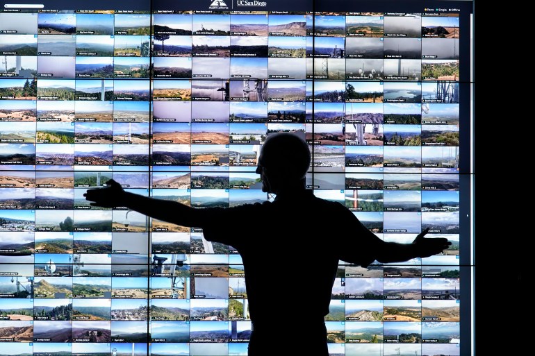 ap23263030938241-1695662422 Falco Kuester, a researcher at ALERTCalifornia, a program run by the University of California San Diego, looks at live feeds from some of the program's cameras, Monday, Sept. 18, 2023, in San Diego. California's main firefighting agency, Cal Fire, in July started trying out an artificial intelligence system that looks for smoke from more than 1,000 mountaintop cameras feeds. (AP Photo/Gregory Bull)