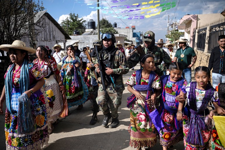 afp__20tion-1707037395 A local self-defense force member attends the Purepecha New Year celebration in Ocumicho, Michoacan State, Mexico, on February 1, 2024. - Every year, Purepecha’s Indigenous people from different regions of Michoacan State celebrate the Fuego Nuevo Purepecha (Purepecha’s New Fire), a fire lighting ceremony to mark the start of the new year. (Photo by CARL DE SOUZA / AFP)