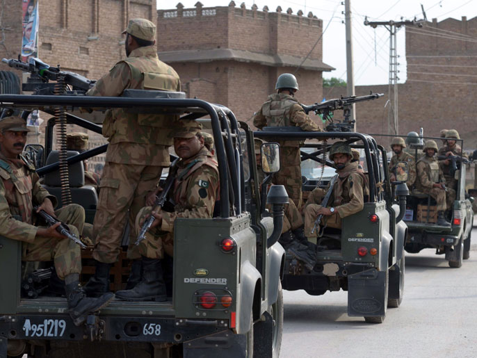 ea1ebde3-64da-4a3f-9405-b1688f2ae855 AQ765 - Peshawar, -, PAKISTAN : A Pakistani army convoy patrols the streets on the outskirts of Peshawar on May 10, 2013. Pakistan goes to the polls on May 11 to elect a new government, the first time in the country's turbulent history that one civilian administration has handed power to another through the ballot box. AFP PHOTO/ A. MAJEED