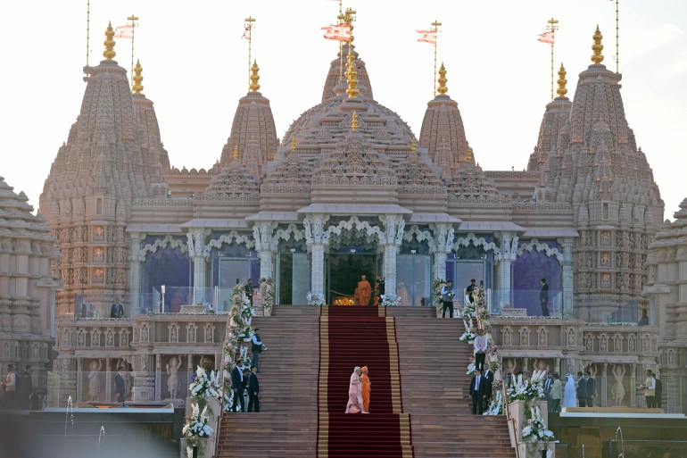 pic-55671-1707950710 Indian Prime Minister Narendra Modi, left, walks across the carpeted steps with Hindu priest Brahmaviharidas Swami to inaugurate the first stone-built Hindu temple in the Middle East, belonging to Bochasanwasi Akshar Purushottam Swaminarayan Sanstha in Abu Mureikha, 40 kilometers (25 miles) northeast of Abu Dhabi, United Arab Emirates, Wednesday, Feb. 14, 2024. (AP Photo/Kamran Jebreili)