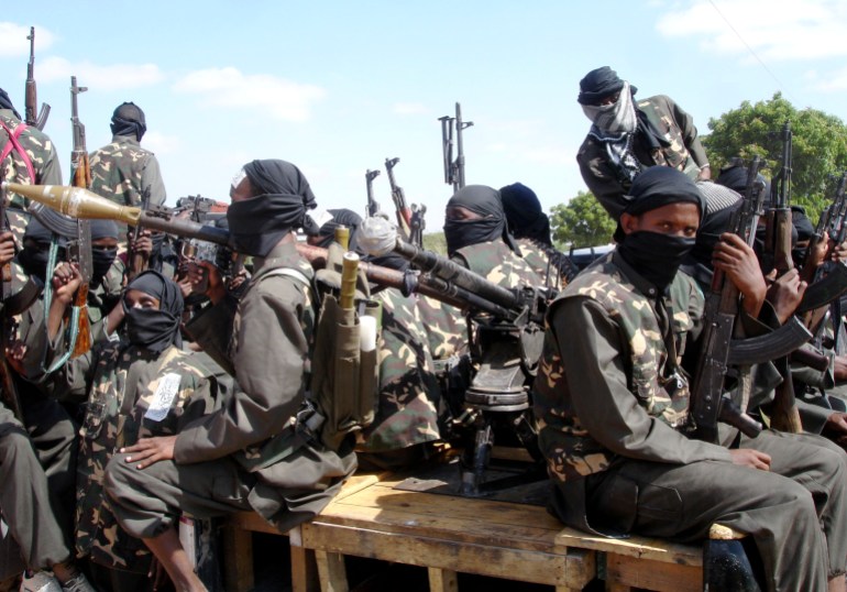somalia1-1708806511 Militants of al Shabaab display their weapons on the outskirts of Mogadishu, December 8, 2008. The hardline Islamist insurgent group al Shabaab has taken control of a central Somali trading town after fighting that killed at least 13 people and wounded dozens of others, residents said. REUTERS/Feisal Omar (SOMALIA)