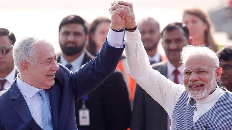 480f0433-0f02-4710-a648-93d369a1524f Israeli Prime Minister Benjamin Netanyahu and his Indian counterpart Narendra Modi raise their arms upon Netanyahu’s arrival at Air Force Station Palam in New Delhi, India, January 14, 2018. REUTERS/Adnan Abidi