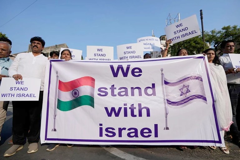 652d3f940c40e-1699374909 People hold placards and a banner in solidarity with Israel in Ahmedabad, India, Oct. 16, 2023. Credit: AP Photo/Ajit Solanki