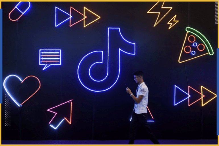 d8b5d988d8b1d8a9-d985d98ad8afd8a7d986-2020-08-23t133613-216 A man holding a phone walks past a sign of Chinese company ByteDance's app TikTok, known locally as Douyin, at the International Artificial Products Expo in Hangzhou, Zhejiang province, China October 18, 2019. Picture taken October 18, 2019. REUTERS/Stringer ATTENTION EDITORS - THIS IMAGE WAS PROVIDED BY A THIRD PARTY. CHINA OUT.