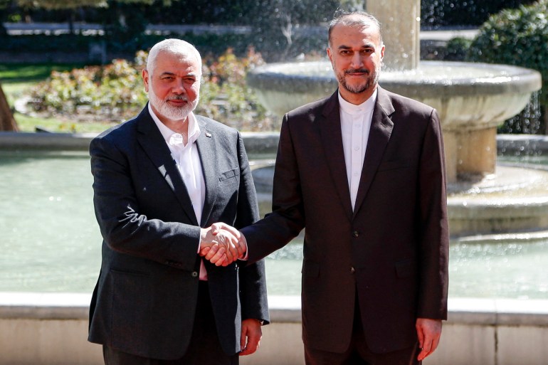 d9a1-1711471844 Iran's Foreign Minister Hossein Amir-Abdollahian (R) receives Hamas' Doha-based political bureau chief Ismail Haniyeh at the foreign ministry headquarters in Tehran on March 26, 2024. - Haniyeh's visit to Tehran comes a day after a resolution adopted by the UN Security Council called for an "immediate ceasefire" for the ongoing Muslim holy month of Ramadan, leading to a "lasting" truce. (Photo by AFP)