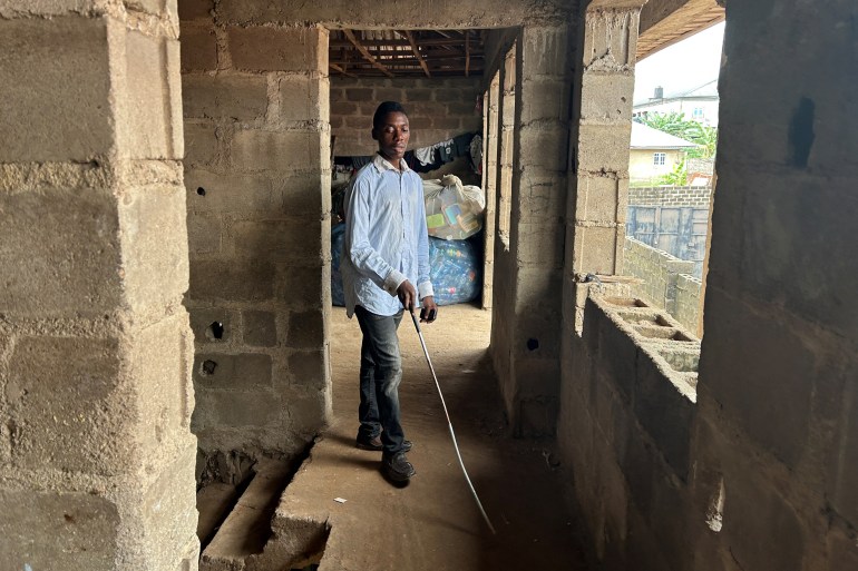 d9a2-1710508928 Visually-impaired Kehinde Olubotusun, who struggled to find information because he has no smartphone, and who is using an Artificial-Intelligence-powered mobile phone that works offline, walks at his house in Alimosho local government district in Lagos, Nigeria February 23, 2024. REUTERS/Seun Sanni