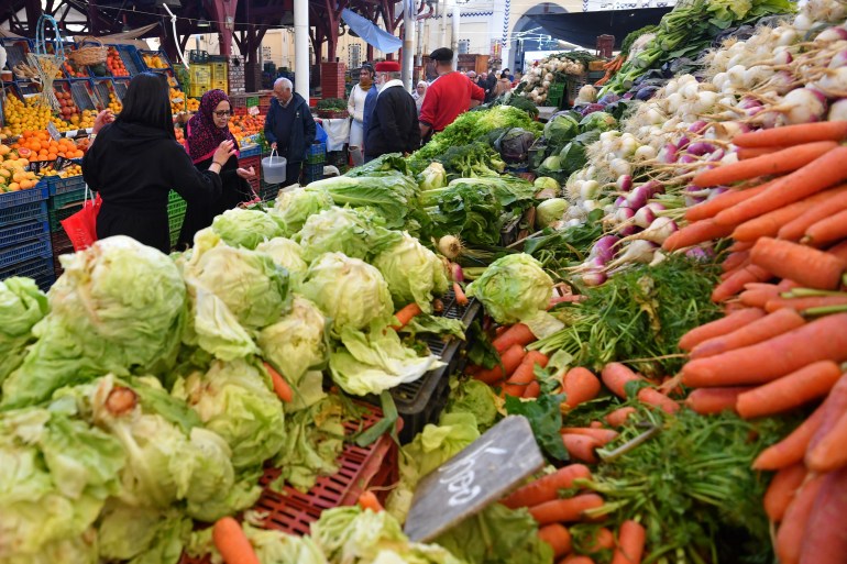 People buy vegetables at the central market ahead of the holy fasting month of Ramadan, in Tunis on March 6, 2024. - For Muslims across the world, the beginning of the ninth month in the Muslim lunar calendar which marks the start of Ramadan, is a time for spiritual reflection, prayers, fasting and family reunions around the table after breaking the fast. (Photo by FETHI BELAID / AFP)