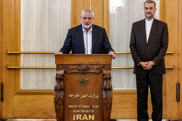 d9a2-1711471860 Ismail Haniyeh (L), the Doha-based political bureau chief of the Palestinian Islamist movement Hamas, speaks to the press after a meeting with the Iranian Foreign Minister Hossein Amir-Abdollahian (R) in Tehran on March 26, 2024. - Haniyeh's visit to Tehran comes a day after a resolution adopted by the UN Security Council called for an "immediate ceasefire" for the ongoing Muslim holy month of Ramadan, leading to a "lasting" truce. (Photo by AFP)