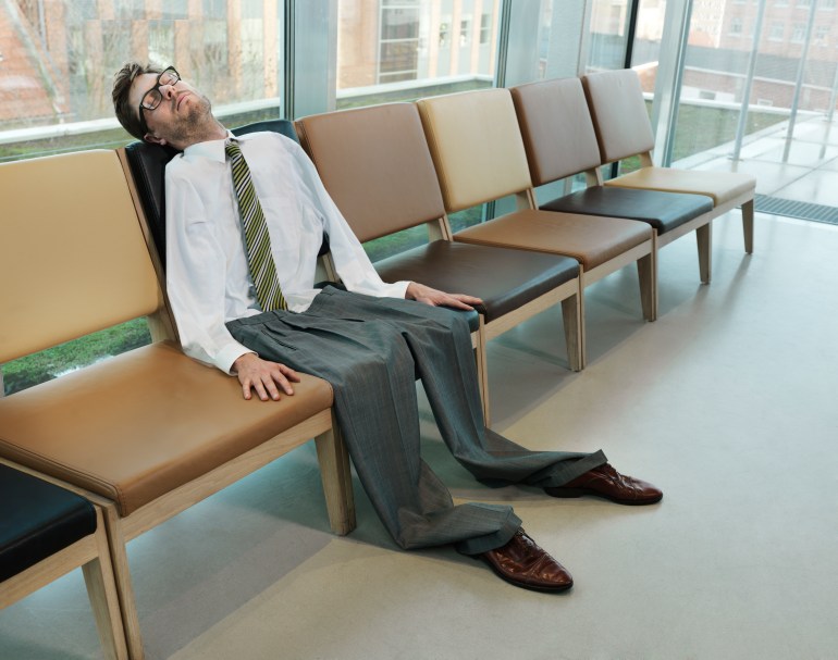 gettyimages-136630739-1713291163 Businessman on a row of chairs with a deflated body. sleeping