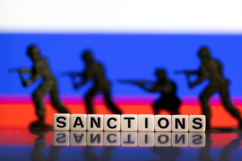 wtrea-1682878878 FILE PHOTO: Plastic letters arranged to read "Sanctions" and solider toys are placed in front of Russia's flag colors in this illustration taken February 25, 2022. REUTERS/Dado Ruvic/Illustration/File Photo