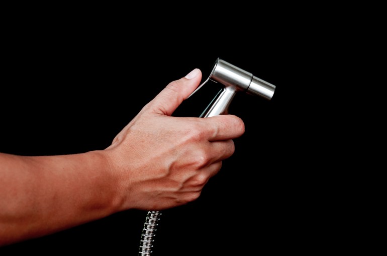 bathroom-bidet1-1716381777 bidet shower in hand isolated on black background