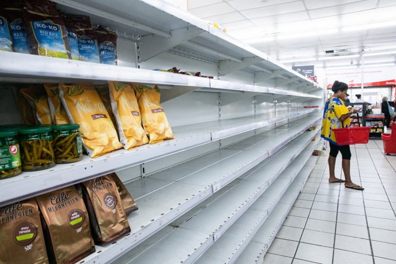 Empty shelves are seen at a supermarket in Noumea on May 16, 2024, amid protests linked to a debate on a constitutional bill aimed at enlarging the electorate for upcoming elections of the overseas French territory of New Caledonia. - France deployed troops to New Caledonia's ports and international airport, banned TikTok and imposed a state of emergency on May 16 after three nights of clashes that have left four dead and hundreds wounded. (Photo by Delphine Mayeur / AFP)