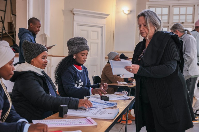gettyimages-2155119002-1716971371 VARIOUS CITIES, SOUTH AFRICA - MAY 29: Residents of Matatiele collect ballots from IEC workers in Matatiele Town Hall to cast the ballots in the National Election May 29, 2024 in Matatiele, South Africa. South Africa's national and provincial elections were held today to elect a new National Assembly and provincial legislature in each of the nine provinces. Results will be officially announced on June 2. (Photo by J. Countess/Getty Images)