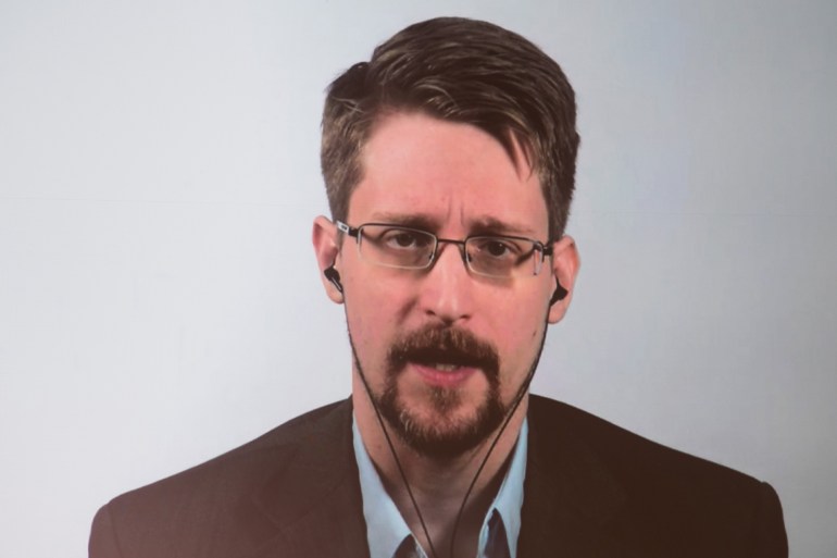 1920-1280-8 US former CIA employee and whistleblower Edward Snowden is displayed on a screen as he speaks during a video conference to present his book titled "Permanent Record" on September 17, 2019 in Berlin. (Photo by Jörg Carstensen / dpa / AFP) / Germany OUT