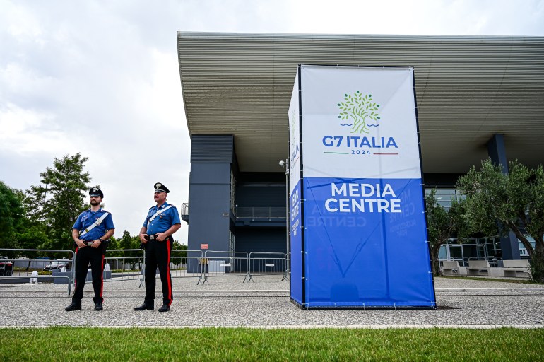 Police officers stand outside the G7 Italy 2024 media centre in Bari, Italy, on June 11, 2024. - Leaders of the G7 wealthy nations gather in southern Italy this week against the backdrop of global and political turmoil, with boosting support for Ukraine top of the agenda. (Photo by Piero CRUCIATTI / AFP)