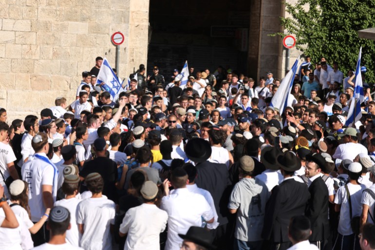 Israeli right-wing activists gather with Israeli national flags outside the Damascus Gate of the old city of Jerusalem on June 5, 2024, during the so-called Jerusalem Day flag march which commemorates the Israeli army's capture in the 1967 Arab-Israeli war of the city's eastern sector home to the Al-Aqsa mosque compound, Islam's third holiest site, which Jews call the Temple Mount. (Photo by Menahem KAHANA / AFP)