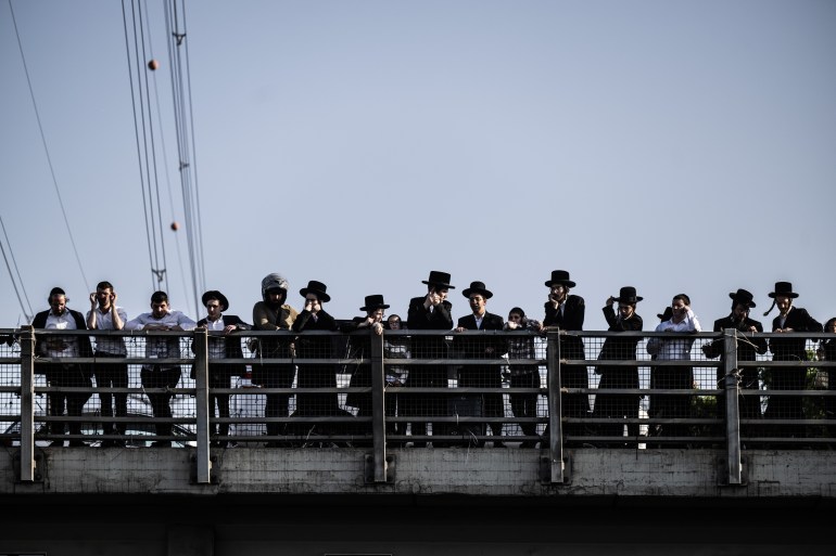 BNEI BRAK, ISRAEL - JUNE 20: Orthodox Jews clash with the Israeli police as they stage a sit-in protest against the compulsory military service at the highway no.4 in Bnei Brak, Israel on June 20, 2024. (Photo by Mostafa Alkharouf/Anadolu via Getty Images)