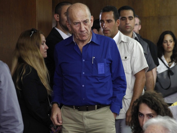 FILE - This May 13, 2014, file photo shows Israel's former Prime Minister Ehud Olmert at the Tel Aviv District Court in Israel. Olmert has been sentenced to eight months in prison for unlawfully accepting money from a U.S. supporter. The Monday, May 25, 2015, verdict in Jerusalem District Court caps a dramatic downfall of a man who only years earlier led the country and hoped to bring about a historic peace agreement with the Palestinians. (AP Photo/Finbarr O'Reilly, File)