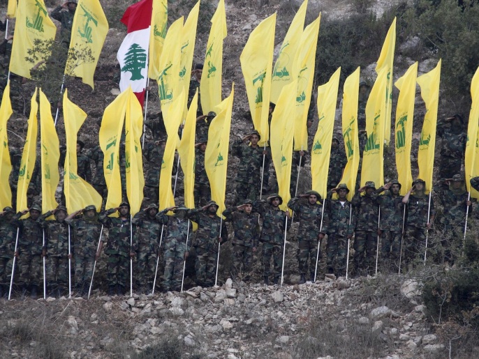 53dce4a7-43da-4214-89c0-c3631b0ce07b Members of Lebanon's Hezbollah wave Hezbollah and Lebanese flags during a rally marking the ninth anniversary of the end of Hezbollah's 2006 war with Israel, in Wadi al-Hujeir, southern Lebanon August 14, 2015. REUTERS/Aziz Taher