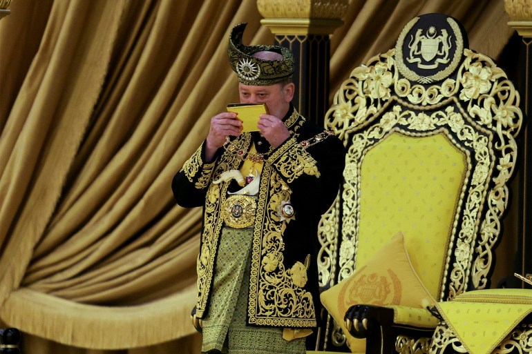 The seventeenth King of Malaysia, Sultan Ibrahim Sultan Iskandar, kisses a copy of the Koran during his coronation at the National Palace in Kuala Lumpur, Malaysia July 20, 2024. REUTERS/Hasnoor Hussain/Pool