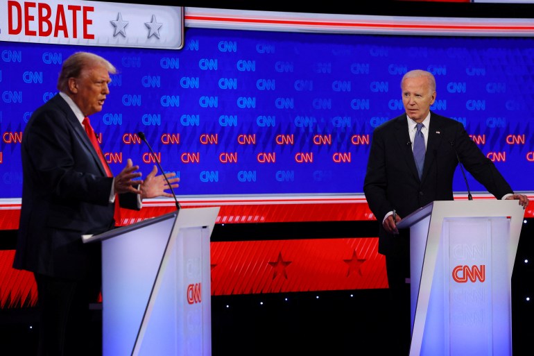 Democrat presidential candidate U.S. President Joe Biden listens as Republican presidential candidate and former U.S. President Donald Trump speaks during their debate in Atlanta, Georgia, U.S., June 27, 2024. REUTERS/Brian Snyder