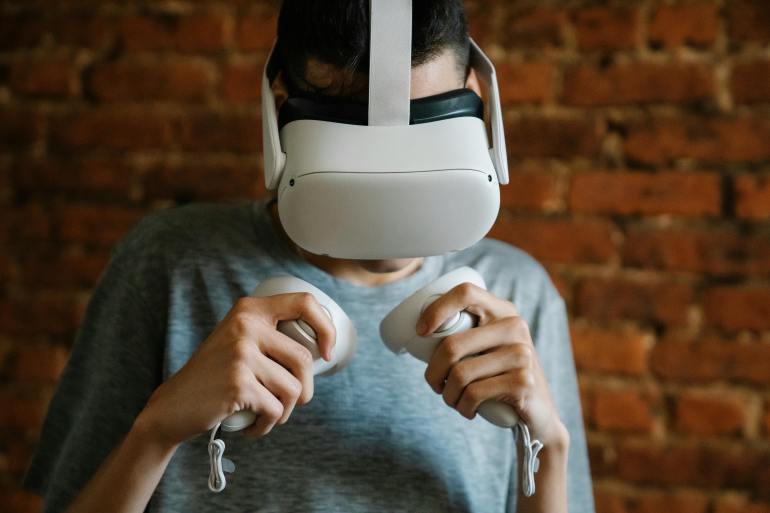 d8aed988d8b0-1720857824 Man in VR headset against brick wall