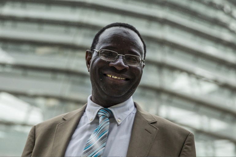 di89-1720082925 New member of parliament for the Social Democratic Party (SPD) Karamba Diaby poses for pictures in front of the cupola of the Reichstag, the seat of Germany's lower house of parliament, the Bundestag, in Berlin, September 24, 2013. رويترز
