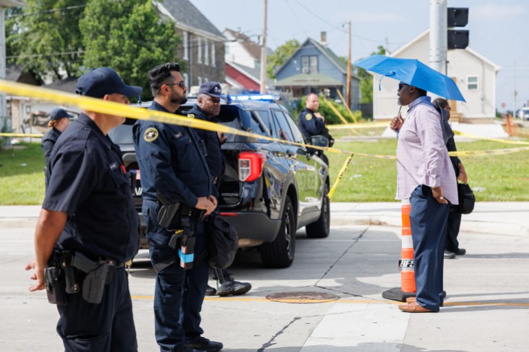MILWAUKEE, UNITED STATES - JULY 16: A community member speaks to police at the intersection of 13th and Vliet, just outside of the security perimeter for the Republican National Convention in Milwaukee, Wisconsin on July 16, 2024, near where one person died after a police-involved shooting. (Photo by Bryan Olin Dozier/Anadolu via Getty Images)