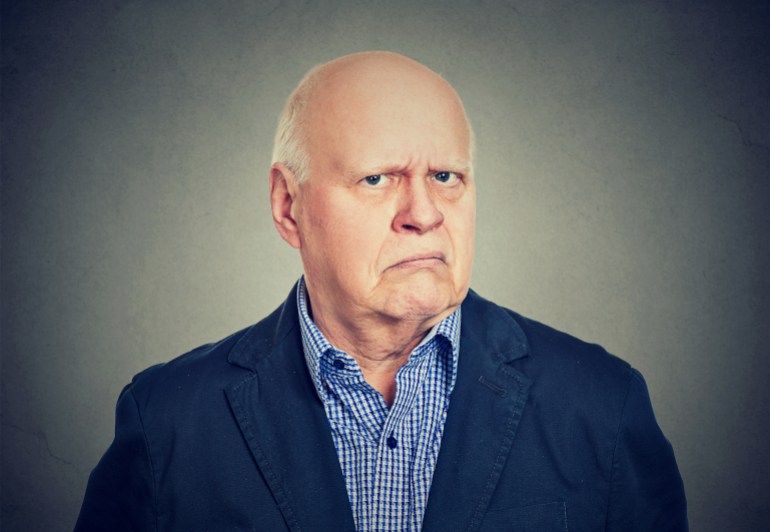 gettyimages-673057226-1722008104 Portrait of an angry, grumpy senior business man, isolated on gray background