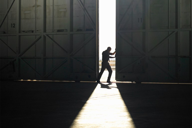 gettyimages-82186105-1721668702 Man pushing door open - stock photo