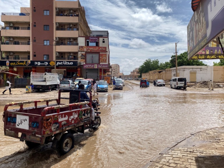 A person drives a vehicle through a flooded street, following a heavy rainfall in Kassala, eastern Sudan, July 26, 2024. REUTERS/Mohammed Abdel Majid