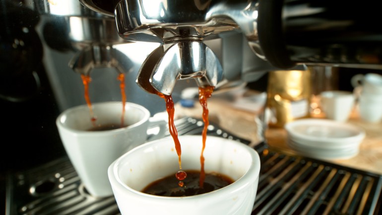 shutterstock_1875187942-1721814950 prepares espresso in his coffee shop; close-up