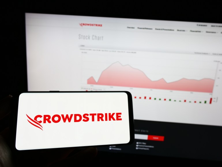 shutterstock_2286276775-1721566427 Stuttgart, Germany - 03-31-2023: Person holding mobile phone with logo of cybersecurity company CrowdStrike Holdings Inc. on screen in front of web page. Focus on phone display. Unmodified photo.