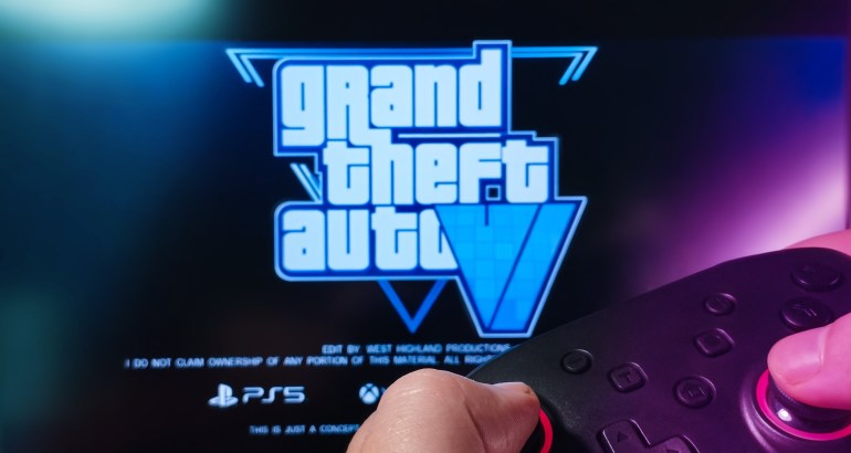 shutterstock_2393296357-1721210740 Person playing GTA VI with a joystick.