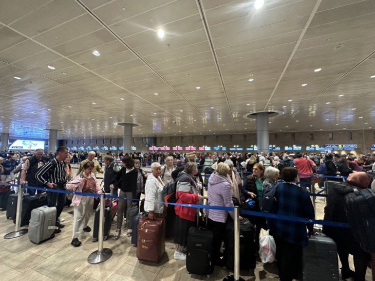 32347140-1699034644 Ben Gurion Airport remains empty due to attacks by Palestinian factions in Israel- - TEL AVIV, ISRAEL - OCTOBER 8: People wait in departing section at Ben Gurion Airport, Israel's only international airport, after many flights from abroad are cancelled due to the attacks launched by Palestinian factions in Tel Aviv, Israel on October 8, 2023.
