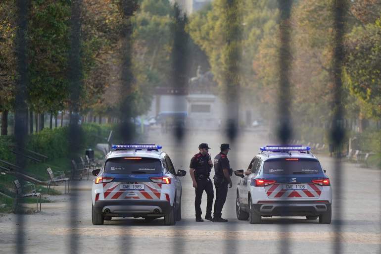 Catalan regional police forces Mossos d'Esquadra officers stand guard as hardline separatist JxCAT party has scheduled a welcome ceremony for Catalonia's exiled separatist leader Carles Puigdemont ahead of an investiture vote, in front of the Parliament of Catalonia, in Barcelona on August 8, 2024. Catalonia's parliament is set to elect a new leader for the Spanish region, but the planned return of exiled separatist leader Carles Puigdemont even though he faces arrest threatens to derail the event. After months of negotiations following an inconclusive May regional election, the leader of the local branch of Spain's ruling Socialists Salvador Illa is poised to become Catalonia's new leader. But the vote could be upended if Puigdemont -- who fled to Belgium shortly after Catalonia's failed 2017 independence bid to avoid prosecution -- returns to Spain and is arrested. (Photo by CESAR MANSO / AFP)