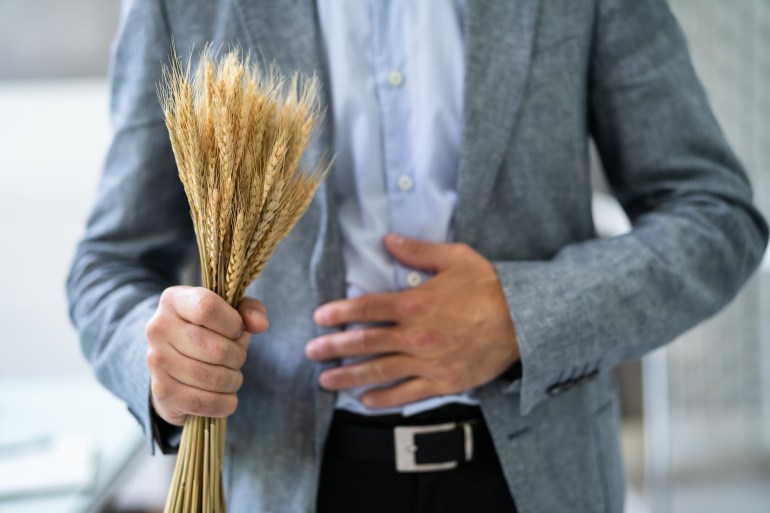 gettyimages-1409041679-1723460717 Celiac Disease And Gluten Intolerance. Women Holding Spikelet Of Wheat