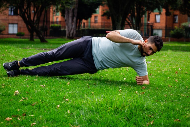gettyimages-1742897149-1722960641 young man doing abdominal exercise in a park in the city