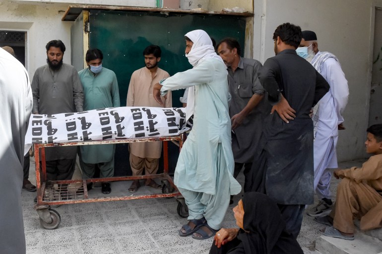 oakistan2-1724688115 Relatives carry the body of a victim, who died in a separatist militants shooting, to a hospital in Quetta on August 26, 2024. - Separatist militants killed at least 39 people in "coordinated" attacks in southwestern Pakistan on August 26, that largely targeted ethnic Punjabis, government officials said. (Photo by Banaras KHAN / AFP)