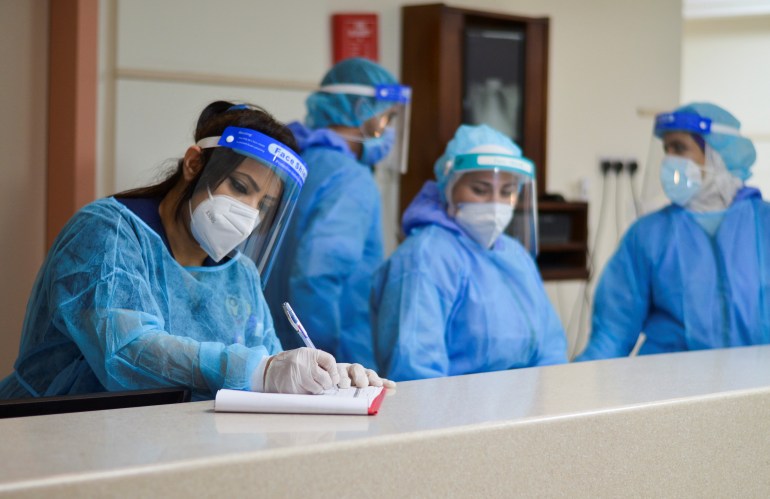 rtxaruul Medical staff members wearing protective gear work at a section for patients suffering from the coronavirus disease (COVID-19), inside a hospital in Amman