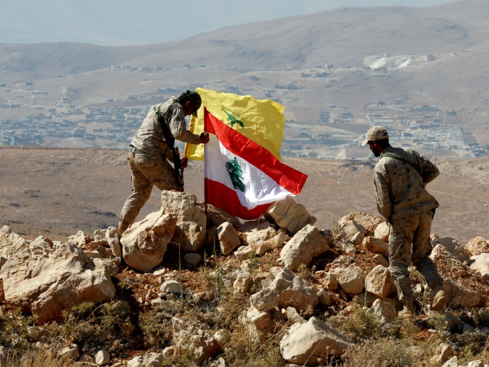 Hezbollah fighters put Lebanese and Hezbollah flags at Juroud Arsal, Syria-Lebanon border, July 25, 2017. Picture taken July 25, 2017. REUTERS/Mohamed Azakir TPX IMAGES OF THE DAY