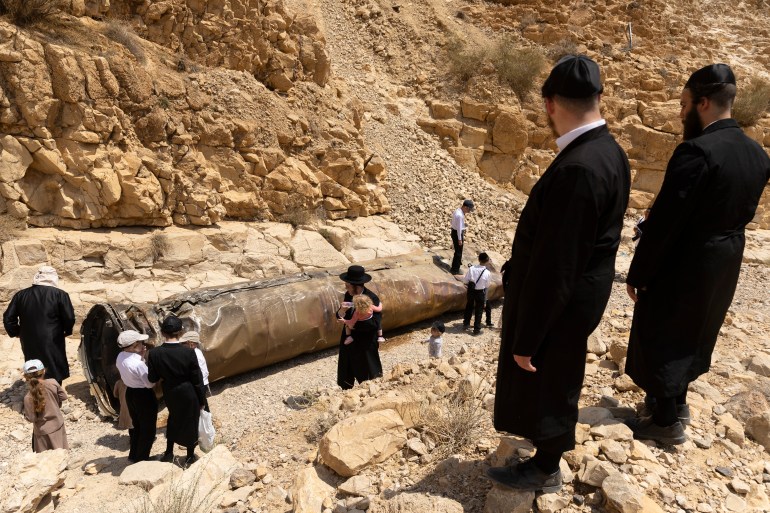 2150312491-1725358171 Missile Debris From Recent Iranian AttackARAD, ISRAEL - APRIL 30: Ultra-Orthodox Jews observe a missile debris located at a channel near the city of Arad on April 30, 2024 in Arad, Israel. The missile debris resulted from Iran's aerial barrage on April 13, when the country launched a reported 170 drones and over 150 missiles at the country and the Israeli-occupied Golan Heights. (Photo by Amir Levy/Getty Images) DATE 30/04/2024 SIZE 5200 x 3467 Country Israel SOURCE Getty Images/Amir Levy