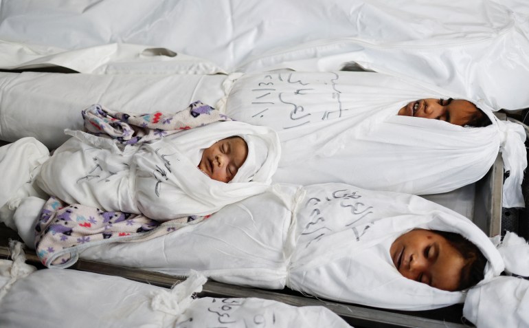 d8a8d8a8-4-1717933580 SENSITIVE MATERIAL. THIS IMAGE MAY OFFEND OR DISTURB Bodies of Palestinian children killed in an Israeli strike, amid the ongoing conflict between Israel and the Palestinian Islamist group Hamas, lie wrapped in white shrouds at Abu Yousef al-Najjar hospital in Rafah, in the southern Gaza Strip, January 11, 2024. REUTERS/Mohammed Salem