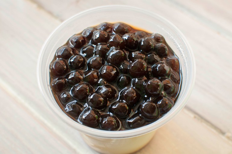 d8b4d8abd982d981d8bad8a7-1725281330 Tapioca on a plastic cup against wooden background