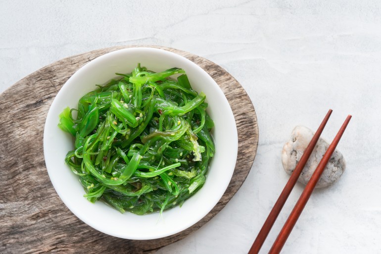shutterstock_1005726052-1727122054 Wakame seaweed salad with sesame seed. Traditional Japanese food. Top view. ; Shutterstock ID 1005726052; purchase_order: AJ; job: ; client: ; other: