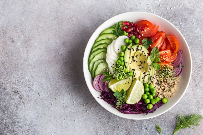 shutterstock_604314275-1727122047 healthy vegan lunch bowl. Avocado, quinoa, tomato, cucumber, red cabbage, green peas and radish vegetables salad. Top view; Shutterstock ID 604314275; purchase_order: AJ; job: ; client: ; other: