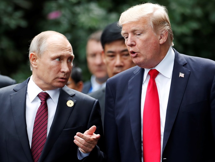U.S. President Donald Trump and Russia's President Vladimir Putin talk during the family photo session at the APEC Summit in Danang, Vietnam November 11, 2017. REUTERS/Jorge Silva