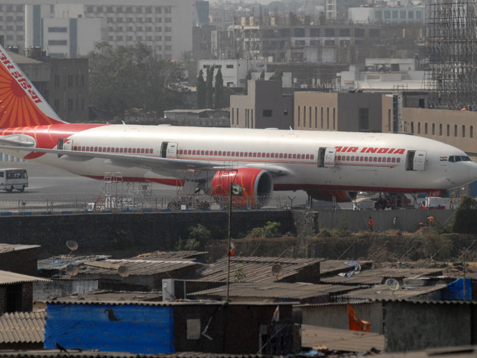 epa03211789 An Air India aircraft is stationary on the tarmac with all doors open, at the airport in Mumbai, India, 09 May 2012. The protest by Air India's pilots continued for the second day and forced the management to cancel twelve international flights in two days.The wildcat strike began early on 08 May as more than 100 pilots reported sick to protest Air India's policy that pilots taken on from the 2007 merger with Indian Airlines also receive training on the Boeing 787 Dreamliner aircraft. The striking pilots demanded they get priority for the training on the new plane, which is to join the Air India fleet at the end of May. They also are seeking faster promotion opportunities, news reports said. EPA/DIVYAKANT SOLANKI